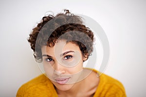 Close up young african american woman posing by white background