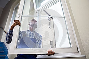 Handyman Installing Window