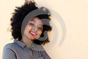 Close up young african woman smiling and thinking