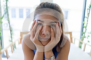 Close up Young Asian girl feeling bore looking through camera wi