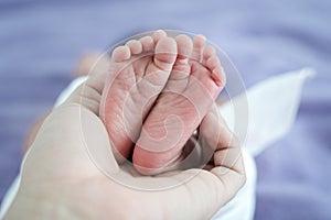 Close up young asian mother kissing her newborn baby. Mom`s love newborn.