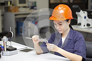 Close up young asian woman engineer using vernier height gauge, engineering in laboratory concept