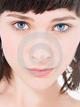 Close up of Young  atrractive Brunette Woman with blue eYES