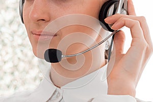 Close up of young beautiful call center worker girl with headphones and microphone posing isolated on white background