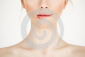 Close up of young beautiful girl with clean healthy skin biting lip over white background. Copy space. Cosmetology and