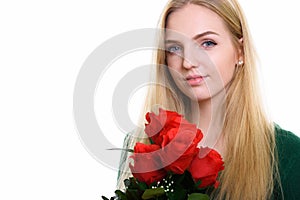 Close up of young beautiful teenage girl holding red roses ready