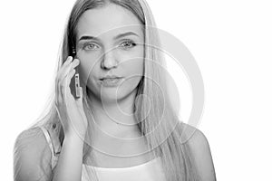 Close up of young beautiful teenage girl talking on mobile phone