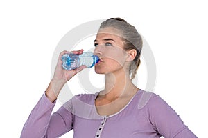Close-up of young beautiful woman drinking water