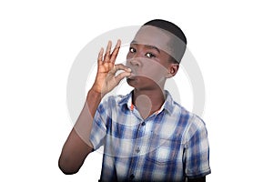 close up of young boy showing kiss gesture