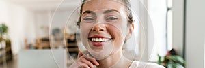 Close up of a young brunette woman casually dressed