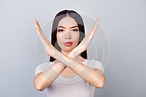 Close up of young brunette woman making stop gesture, forbidding