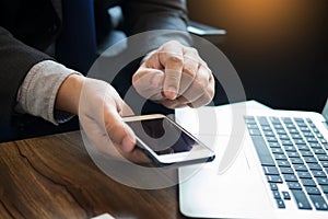 Close up of young business man using mobile smart phone for work