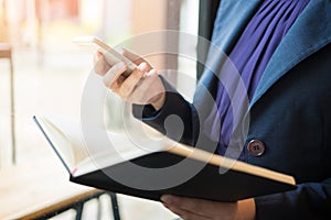 Close up of young business man using mobile smart phone for work