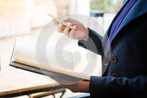 Close up of young business man using mobile smart phone for work