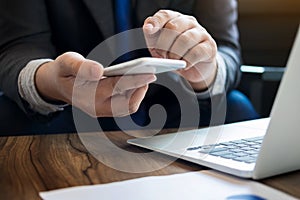 Close up of young business man using mobile smart phone for work