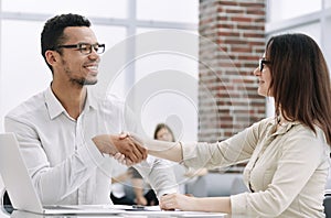 Close up. young business partners shaking hands.