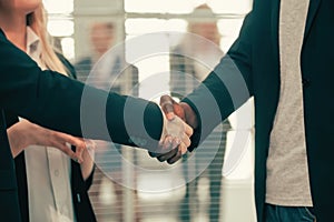 close up. young business people shaking hands with each other.