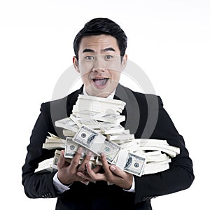 Close up the young businessman carrying a large pile of banknote