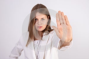 Close-up of young businesswoman making stop gesture