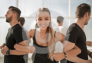 Close up.young businesswoman standing in a circle with a business team