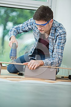 Close up young carpenter at work