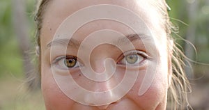 Close-up of a young Caucasian woman with hazel eyes and a subtle smile