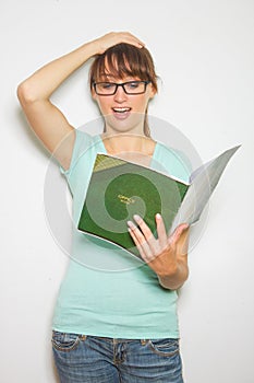 Close-up of young caucasian woman writing on a paper