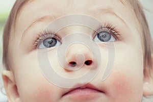 Close up of young child`s blue eyes looking up - Toddler health care concept background