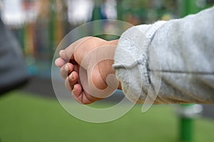 Close up of young child& x27;s outstretched hand reaching for something or someone.