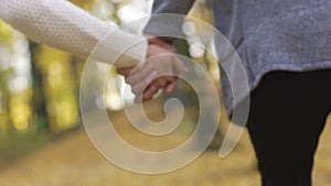 Close-up of young couple clasping hands in slow motion, romantic relationship