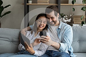 Close up young couple having fun with mobile devices together