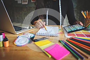 Close-up of young creative fashion designer working project at a modern home office