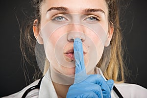 Close-up of young doctor portrait holding making sush gesture