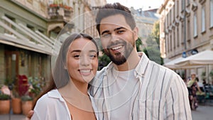 Close up young European Caucasian happy couple woman man together city outside bonding love support closeness sweetheart