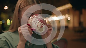 Close up young European woman blonde holding cup drink hot refreshing tasting herbal tea cozy warmth city outside