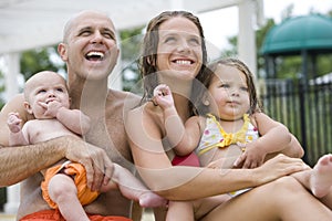 Close-up of young family smiling in swimsuits