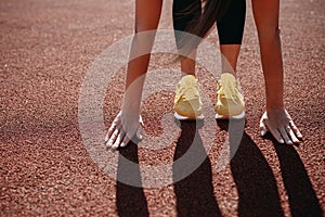 Close up of young fitness woman preparing for morning run