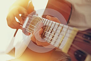 Close up of young girl playing acoustic guitar