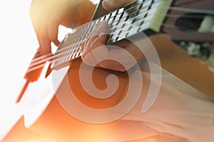 Close up of young girl playing acoustic guitar