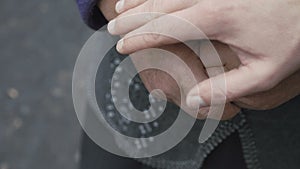 Close up of young hand touches old wrinkled shaking woman`s hands in 4K
