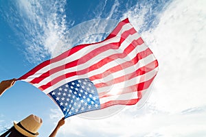 Close up young happy woman holding United States of America flag