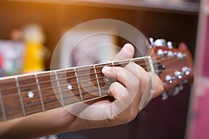 Close up of young hipster woman practiced guitar in the park,happy and enjoy playing guitar photo