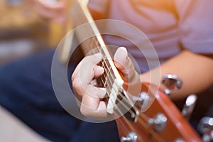 Close up of young hipster woman practiced guitar in the park,happy and enjoy playing guitar photo