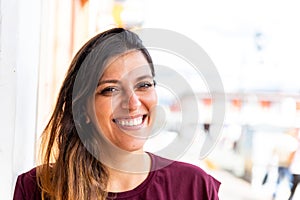 Close Up of a young latina woman smiling and looking at camera outdoors