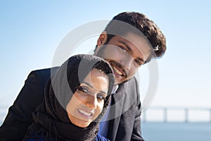 Close-up of young lovely Muslim couple standing close