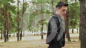 Close up of young man in black costume are dancing Traditional Spanish dance in summer forest