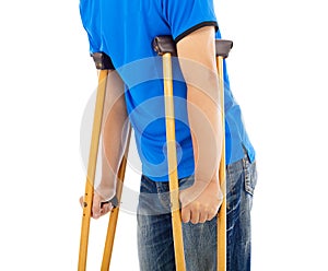 Close up of young man on crutches.