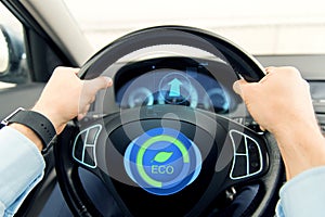 Close up of young man driving car in eco mode