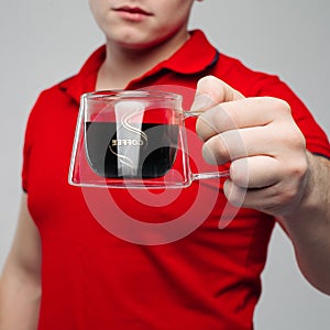 Close up of young man hand holding creative transparent cup. photo