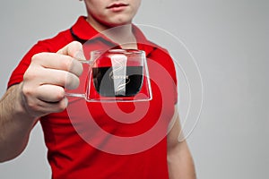 Close up of young man hand holding creative transparent cup. photo